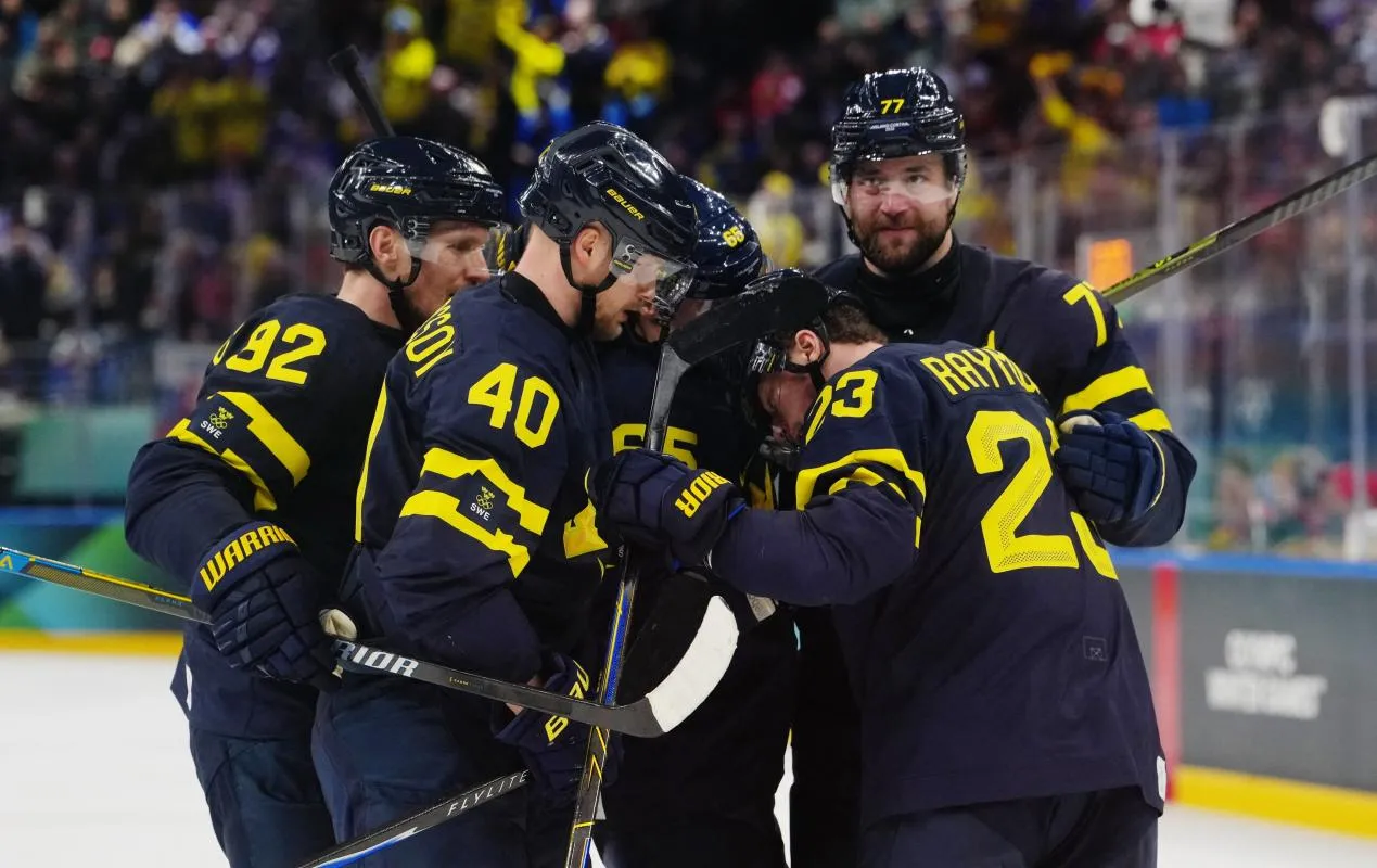 Elias Pettersson of Sweden celebrates scoring their fourth goal with teammates during a Group B men's ice hockey game during the Milano Cortina 2026 Olympic Winter Games at Milano Santagiulia Ice Hockey Arena.
