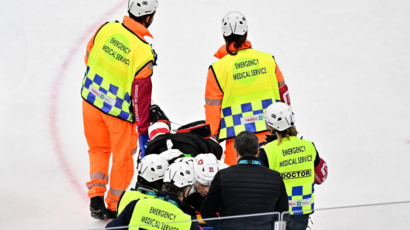 Kevin Fiala of Switzerland is taken off the ice by medical staff on a stretcher after sustaining an injury against Canada in men's ice hockey group A play during the Milano Cortina 2026 Olympic Winter Games at Milano Santagiulia Ice Hockey Arena.