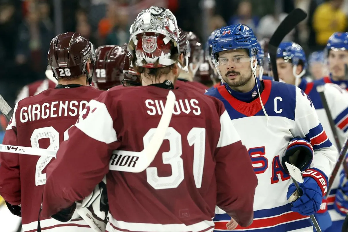 Auston Matthews of United States shakes hands with Arturs Silovs of Latvia after the match in men's ice hockey group C play during the Milano Cortina 2026 Olympic Winter Games at Milano Santagiulia Ice Hockey Arena.