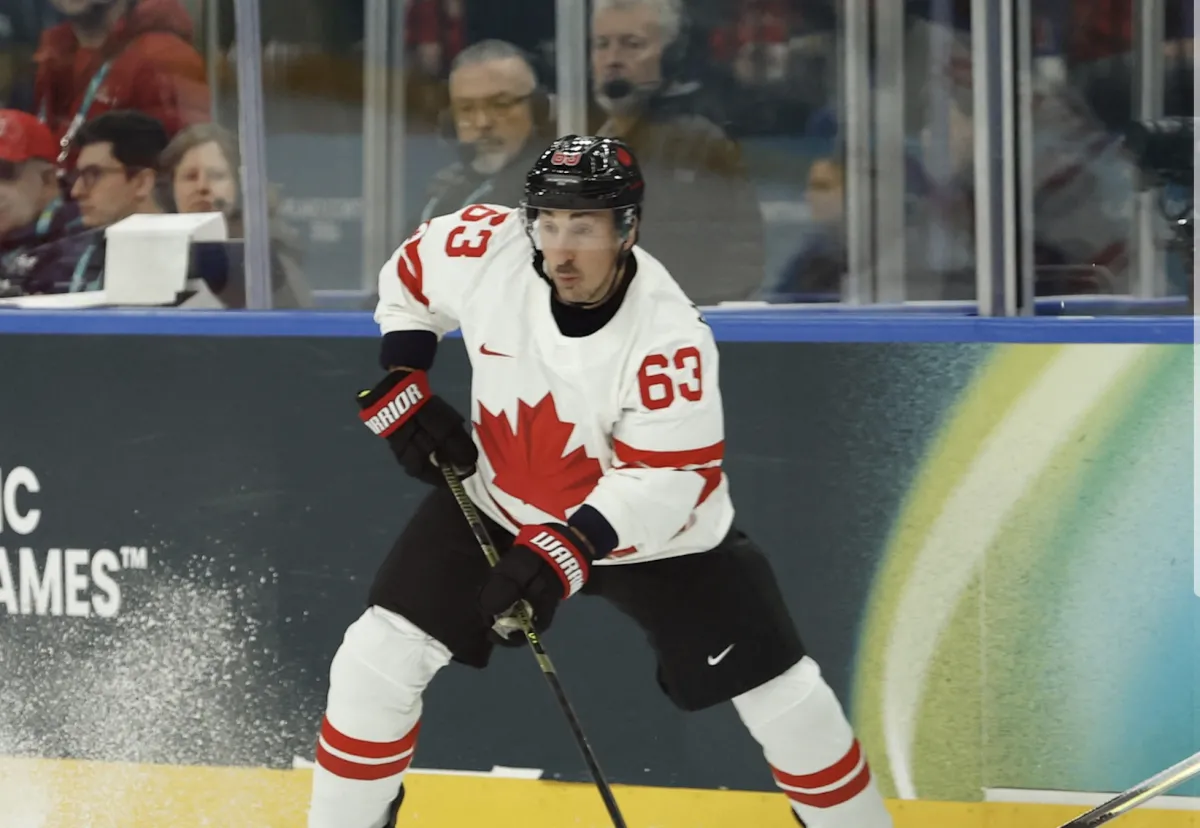 Brad Marchand of Canada in action with Lukas Sedlak of Czechia in a men's ice hockey group A match during the Milano Cortina 2026 Olympic Winter Games at Milano Santagiulia Ice Hockey Arena.