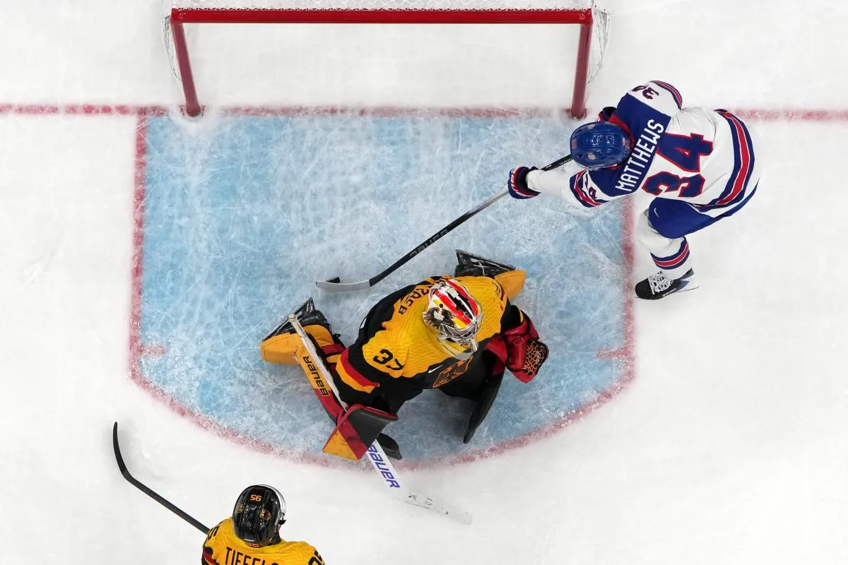 Auston Matthews of United States scores their fifth goal past Maximilian Franzreb of Germany in men's ice hockey group A play during the Milano Cortina 2026 Olympic Winter Games at Milano Santagiulia Ice Hockey Arena.