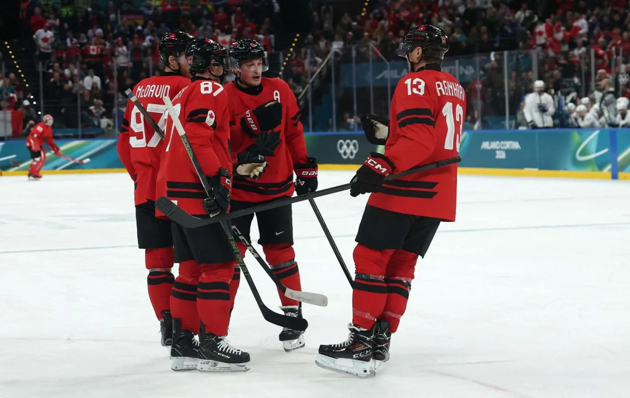 Cale Makar of Canada, Sidney Crosby of Canada, Connor McDavid of Canada and Sam Reinhart of Canada react against France in men's ice hockey group A play during the Milano Cortina 2026 Olympic Winter Games at Milano Santagiulia Ice Hockey Arena.