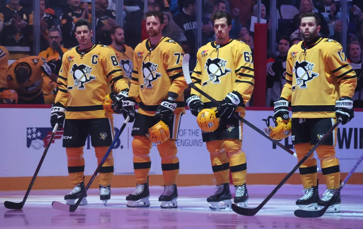 The Pittsburgh Penguins starting line up including center Sidney Crosby (87) and defenseman Brett Kulak (77) and left wing Rickard Rakell (67) and right wing Bryan Rust (17) stand for the national anthem against the Philadelphia Flyers at PPG Paints Arena.