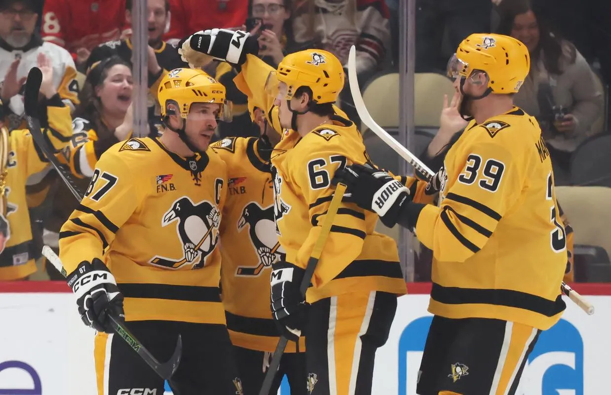 Pittsburgh Penguins right wing Rickard Rakell (67) and right wing Anthony Mantha (39) congratulate center Sidney Crosby (87) on his power play goal against the Detroit Red Wings during the first period at PPG Paints Arena.