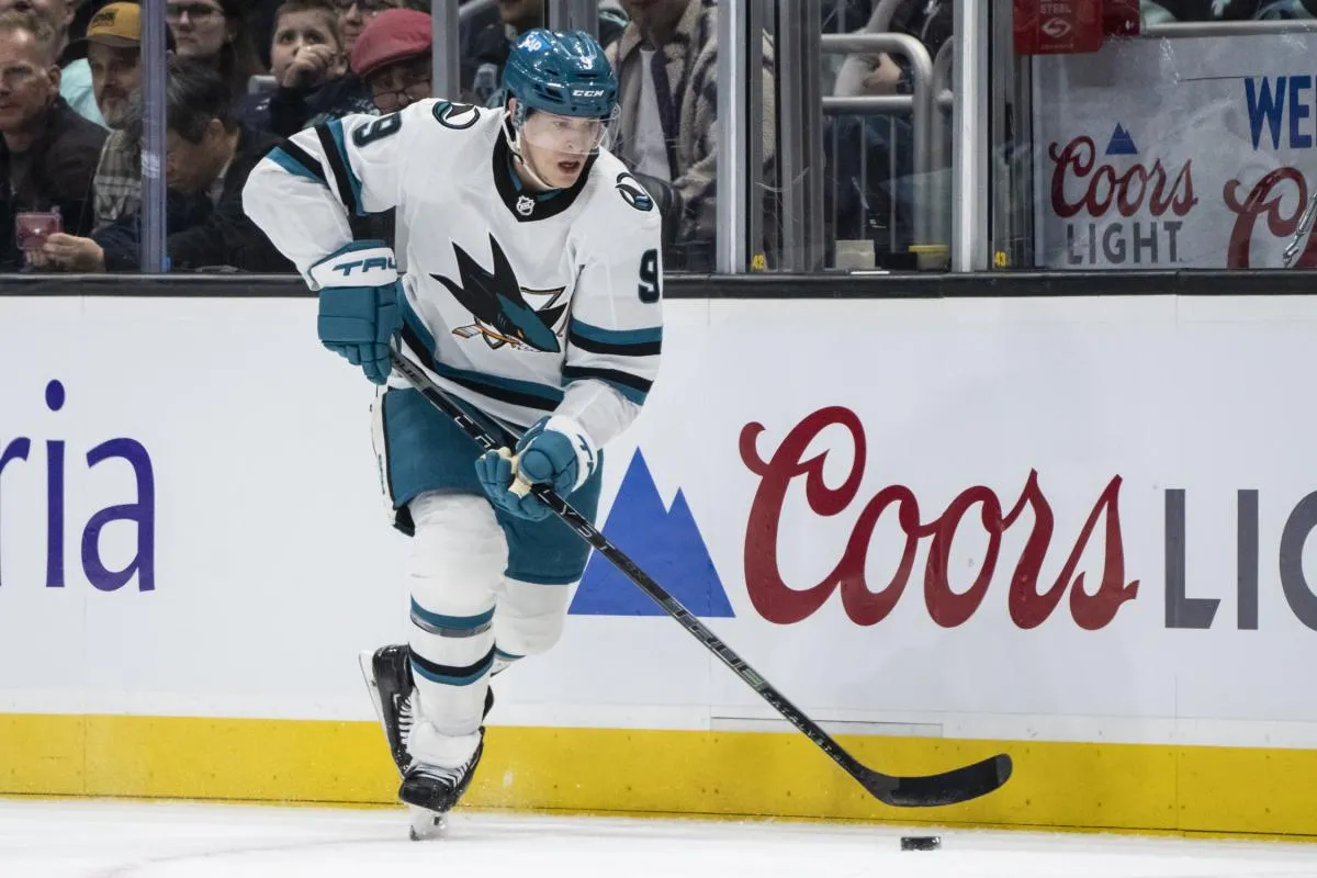 San Jose Sharks defenseman Jacob MacDonald (9) skates with the puck against the Seattle Kraken at Climate Pledge Arena.