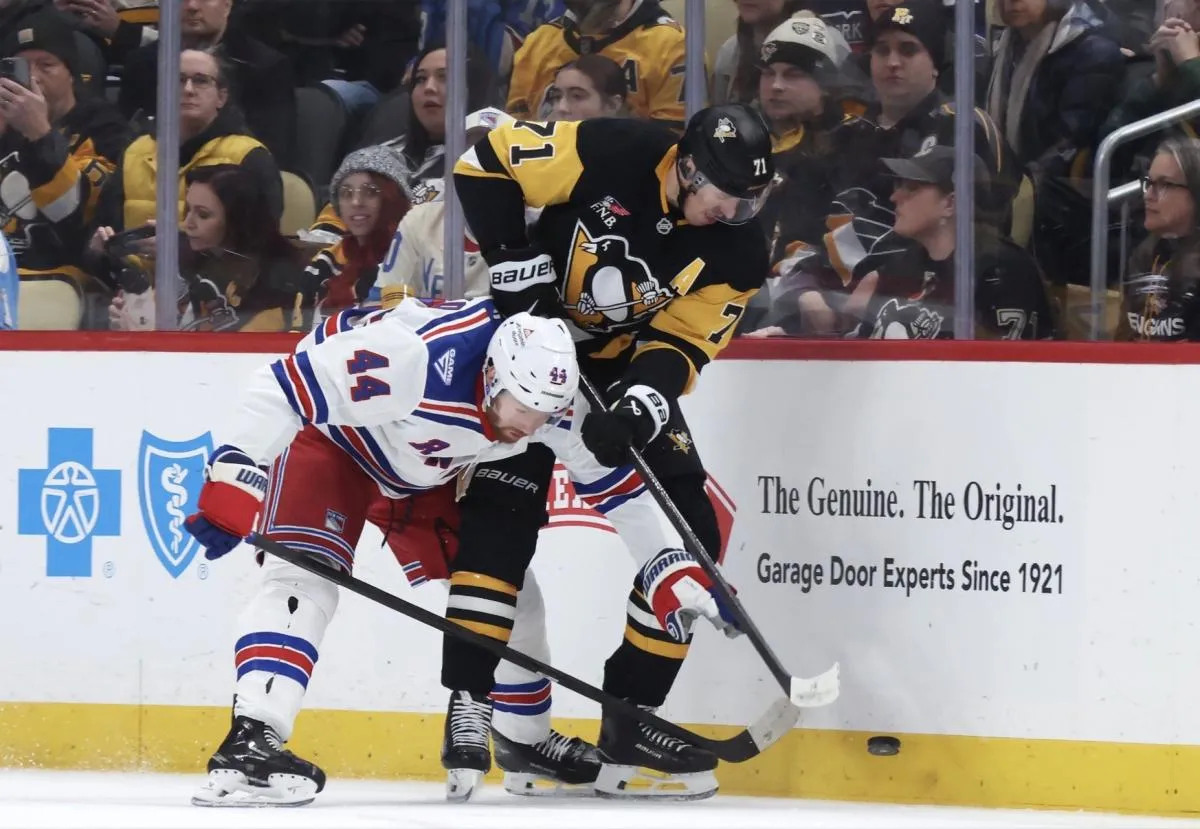 New York Rangers defenseman Vladislav Gavrikov (44) and Pittsburgh Penguins center Evgeni Malkin (71) battle for the puck during the second period at PPG Paints Arena.