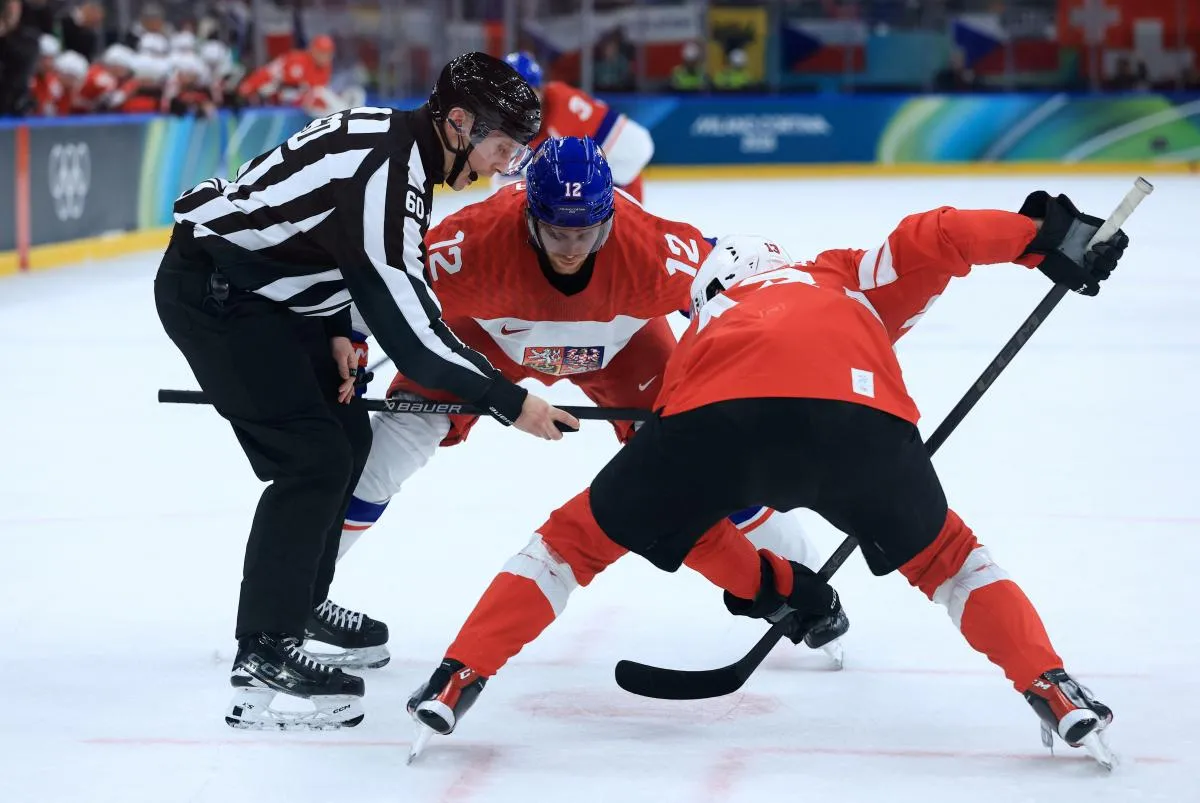 Radek Faksa of Czech Republic in action with Nico Hischier of Switzerland during a face-off in men's ice hockey group A play during the Milano Cortina 2026 Olympic Winter Games at Milano Santagiulia Ice Hockey Arena.
