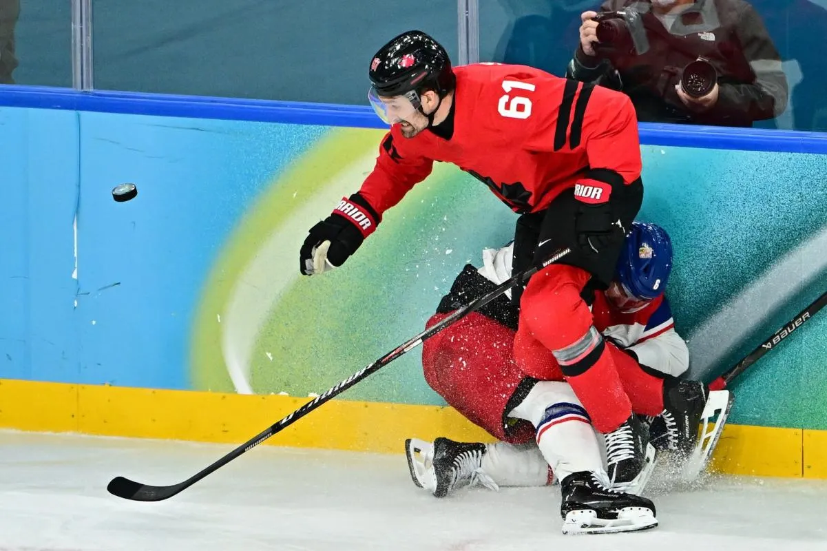Michal Kempny of Czech Republic in action with Mark Stone of Canada in a men's ice hockey quarterfinal during the Milano Cortina 2026 Olympic Winter Games at Milano Santagiulia Ice Hockey Arena.