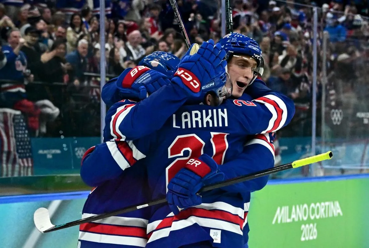 Dylan Larkin of United States celebrates with teammates after scoring their first goal against Sweden in a men's ice hockey quarterfinal during the Milano Cortina 2026 Olympic Winter Games at Milano Santagiulia Ice Hockey Arena.