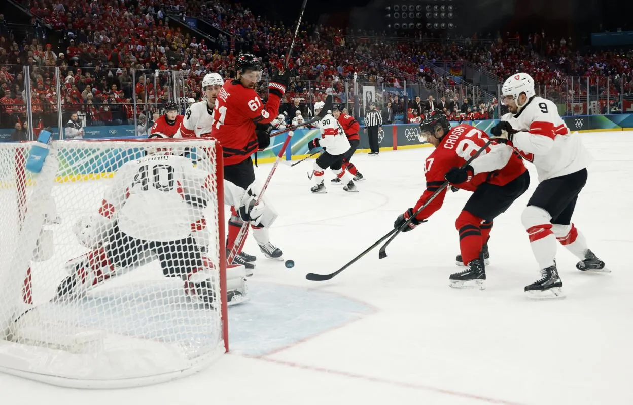 Sidney Crosby of Canada scores their fourth goal against Switzerland in men's ice hockey group A play during the Milano Cortina 2026 Olympic Winter Games at Milano Santagiulia Ice Hockey Arena.