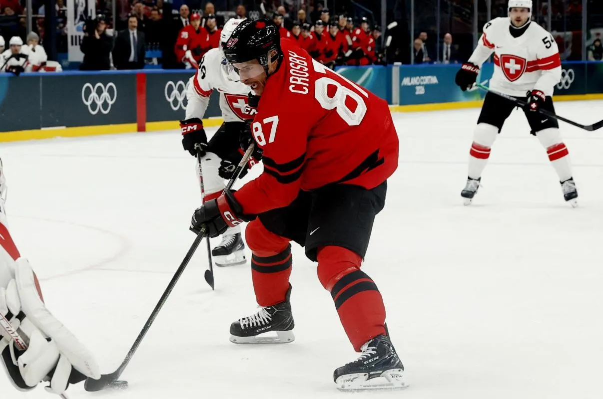Sidney Crosby of Canada in action with Akira Schmid of Switzerland in men's ice hockey group A play during the Milano Cortina 2026 Olympic Winter Games at Milano Santagiulia Ice Hockey Arena.