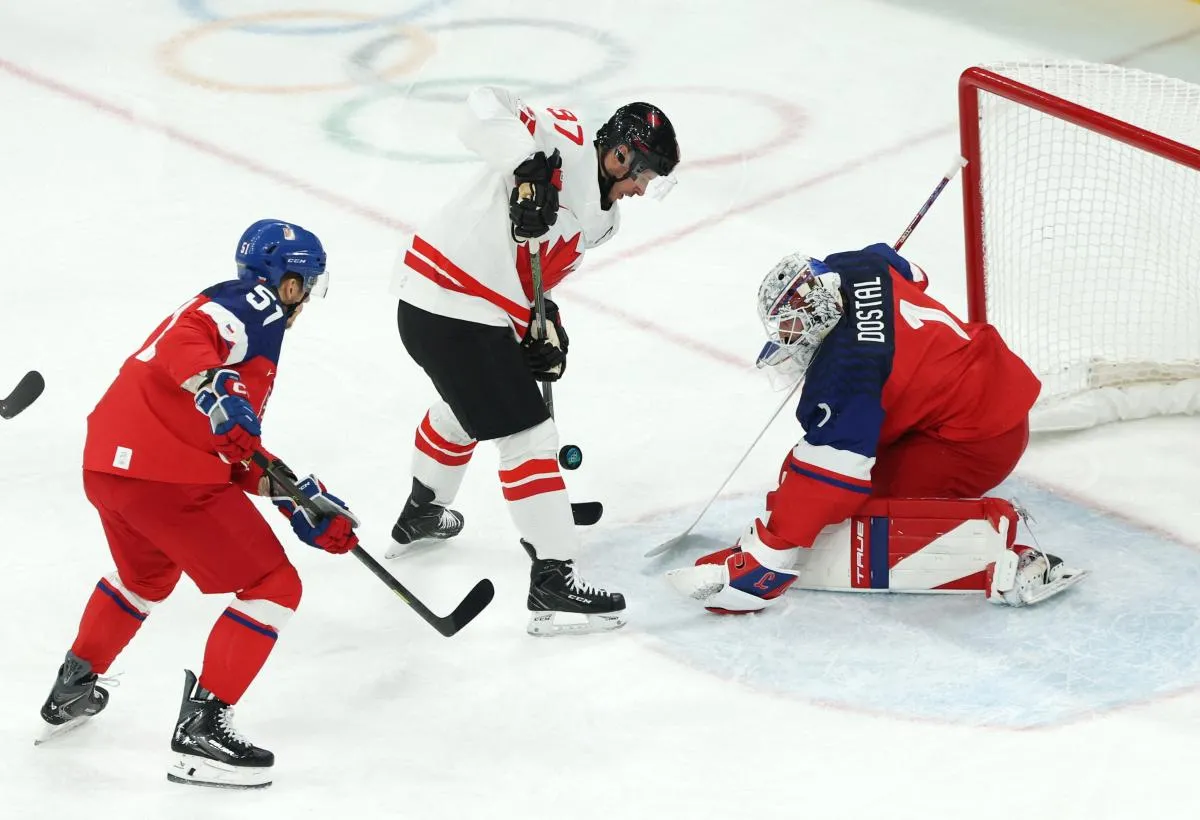 Sidney Crosby of Canada in action with Lukas Dostal of Czechia in a men's ice hockey Group A match during the Milano Cortina 2026 Olympic Winter Games at Milano Santagiulia Ice Hockey Arena.