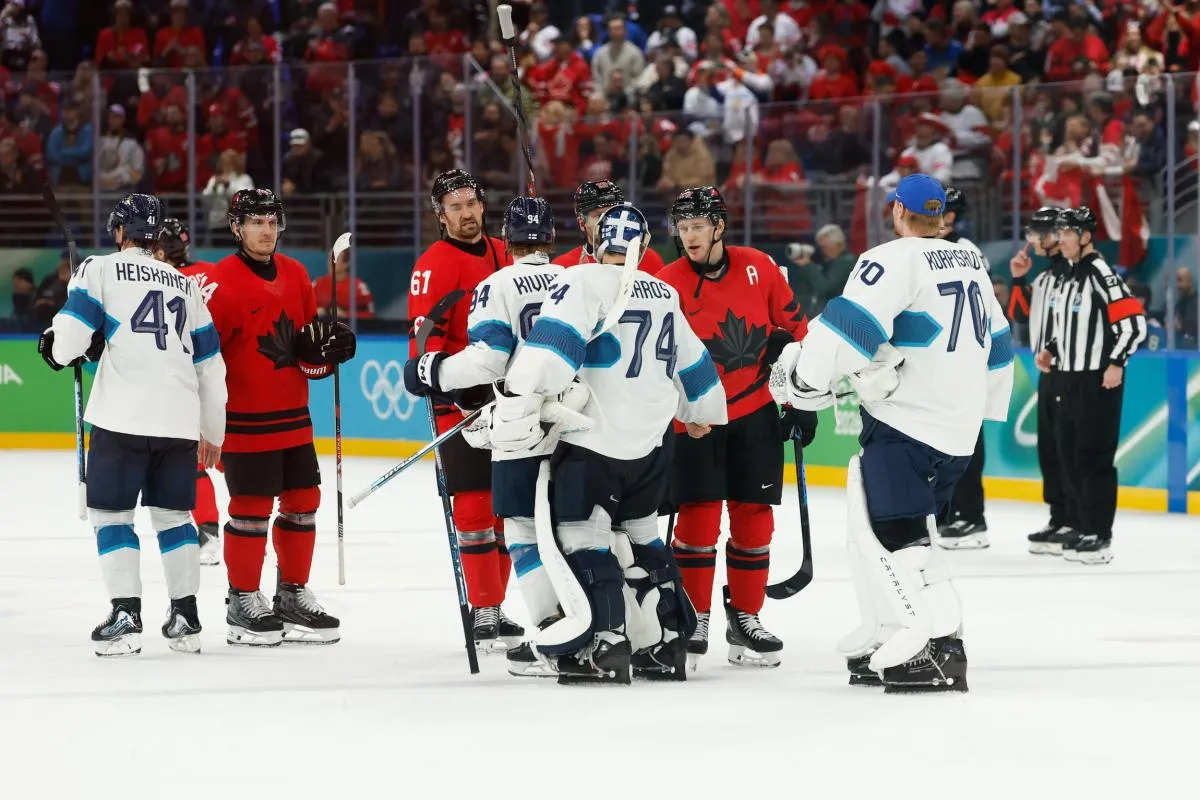 Nathan MacKinnon (29) of Canada greets Juuse Saros (74) of Finland on the ice after the game in a men's ice hockey semifinal during the Milano Cortina 2026 Olympic Winter Games at Milano Santagiulia Ice Hockey Arena.