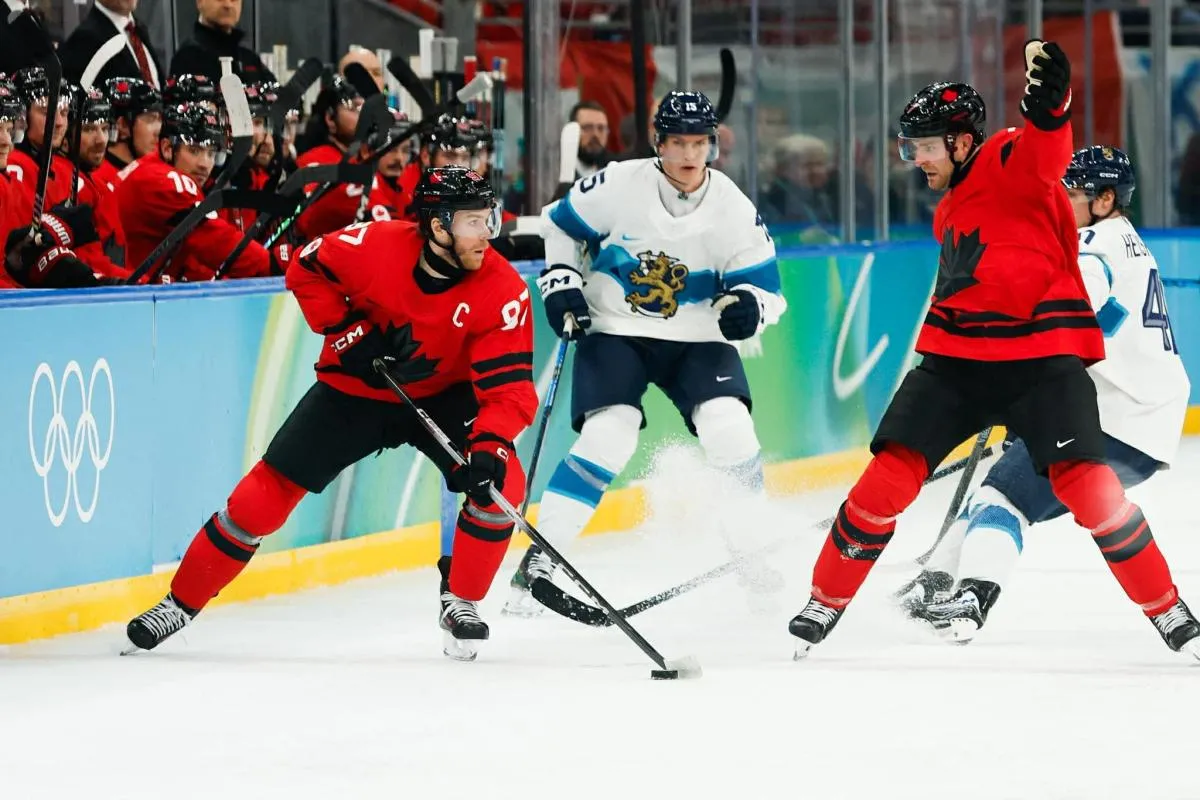 Connor McDavid (97) of Canada looks to pass during the second period against Finland in a men's ice hockey semifinal during the Milano Cortina 2026 Olympic Winter Games at Milano Santagiulia Ice Hockey Arena.