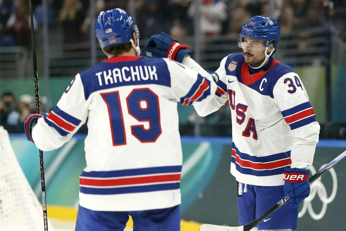 Auston Matthews of United States celebrates scoring their fifth goal with Matthew Tkachuk of United States against Latvia in men's ice hockey group C play during the Milano Cortina 2026 Olympic Winter Games at Milano Santagiulia Ice Hockey Arena.