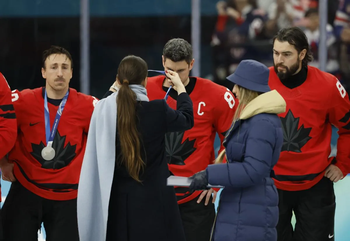 Sidney Crosby (87) of Canada receives the silver medal after the men's ice hockey gold medal against the United States game during the Milano Cortina 2026 Olympic Winter Games at Milano Santagiulia Ice Hockey Arena.