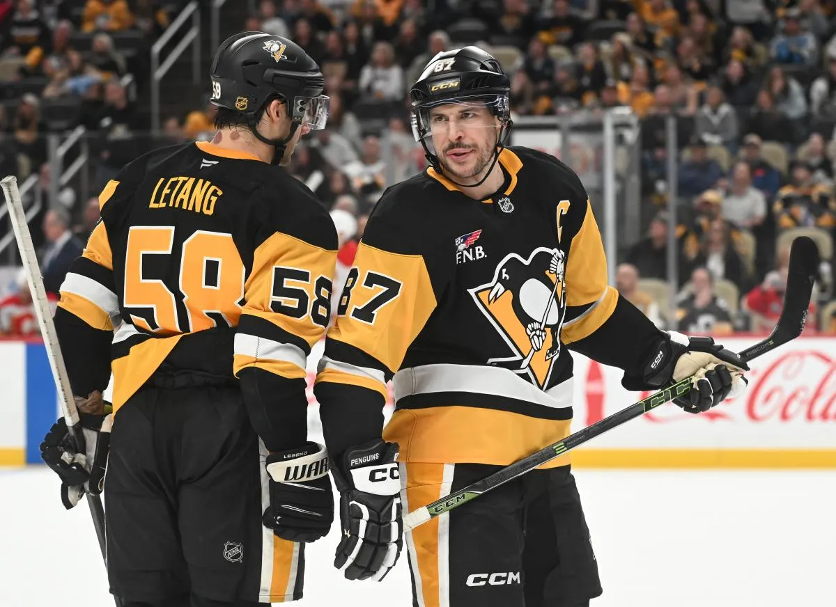 Pittsburgh Penguins center Sidney Crosby (87) and defenseman Kris Letang (58) talk during a break against the Calgary Flames during the third period at PPG Paints Arena.