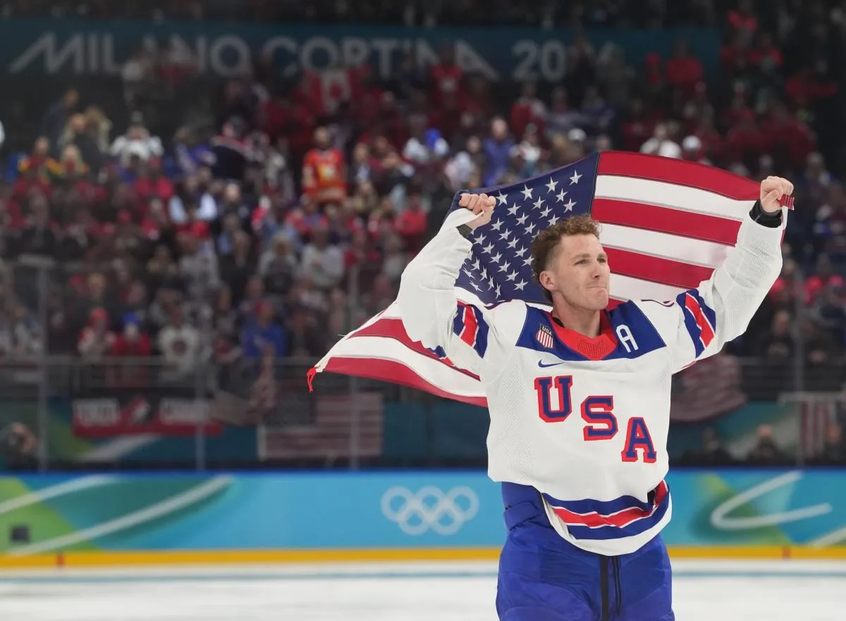 Matthew Tkachuk (19) of the United States celebrates after defeating Canada in the men's ice hockey gold medal game during the Milano Cortina 2026 Olympic Winter Games at Milano Santagiulia Ice Hockey Arena