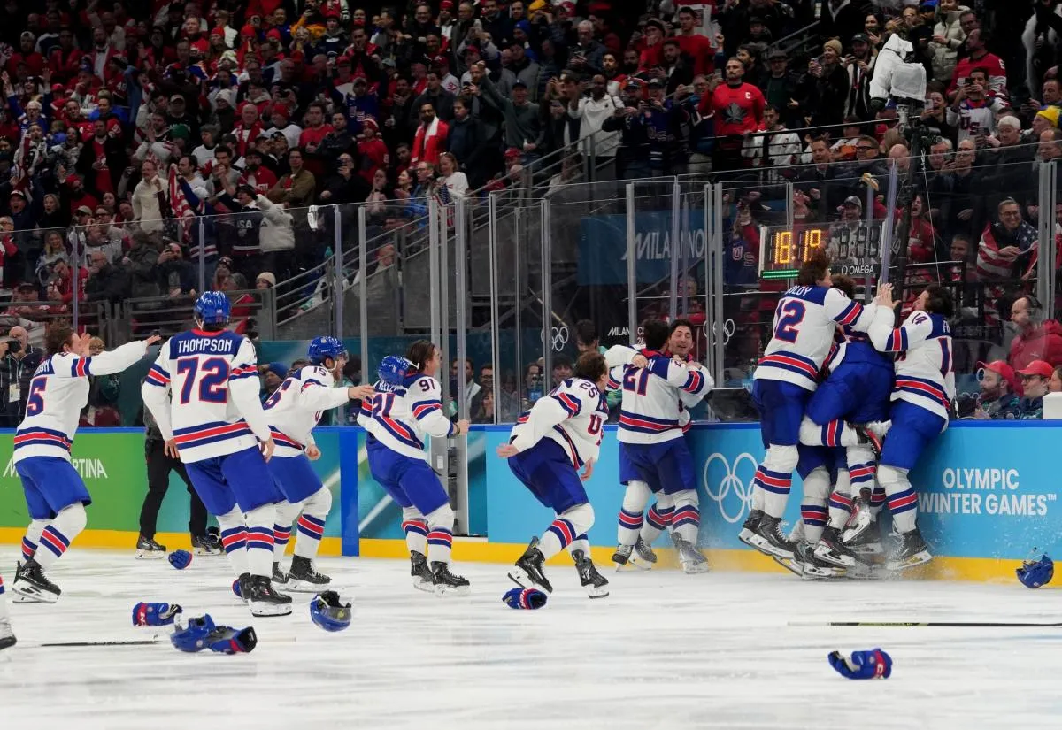Jack Hughes (86) of the United States is congratulated by teammates after scoring the winning goal against Canada in the men's ice hockey gold medal game during the Milano Cortina 2026 Olympic Winter Games at Milano Santagiulia Ice Hockey Arena.