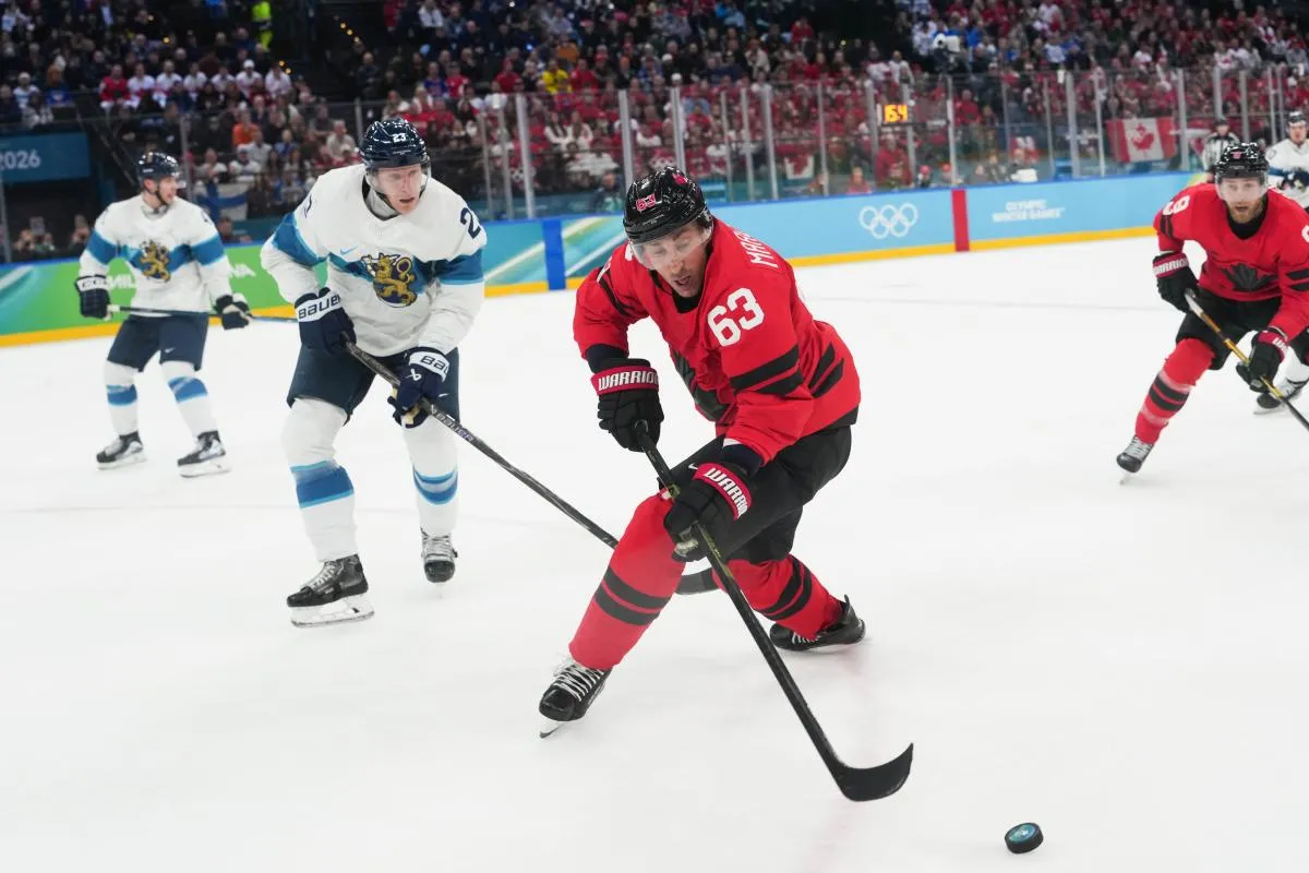 Brad Marchand (63) of Canada controls the puck during the second period against Finland in a men's ice hockey semifinal during the Milano Cortina 2026 Olympic Winter Games at Milano Santagiulia Ice Hockey Arena.