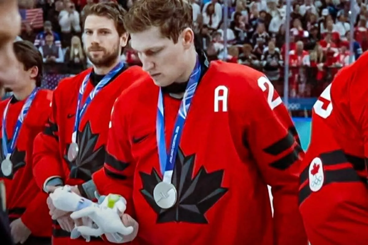Team Canada's Nathan Mackinnon accepts a plush toy with a viral reaction