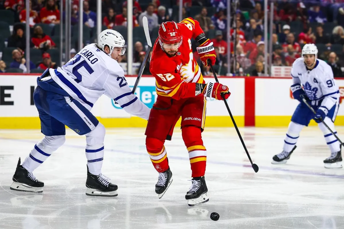 Calgary Flames defenseman MacKenzie Weegar (52) controls the puck against Toronto Maple Leafs defenseman Brandon Carlo (25) during the second period at Scotiabank Saddledome.