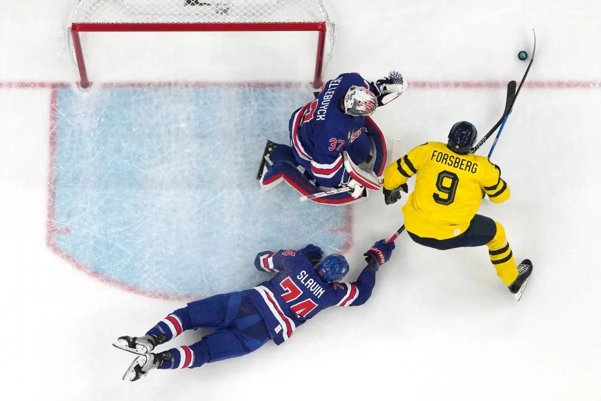 Filip Forsberg of Sweden in action with Jaccob Slavin of United States and Connor Hellebuyck of United States in a men's ice hockey quarterfinal during the Milano Cortina 2026 Olympic Winter Games at Milano Santagiulia Ice Hockey Arena