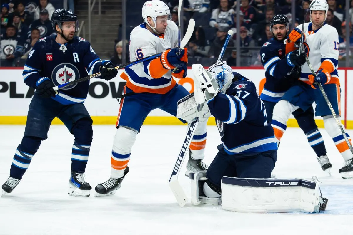 New York Islanders forward Julien Gauthier (16) jostles for position with Winnipeg Jets defenseman Josh Morrissey (44) during the first period at Canada Life Centre.