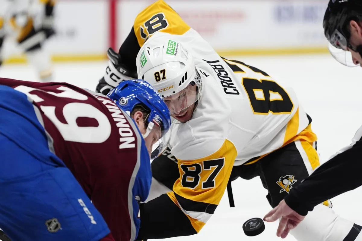 Pittsburgh Penguins center Sidney Crosby (87) and Colorado Avalanche center Nathan MacKinnon (29) take a face-off in the first period at Ball Arena.