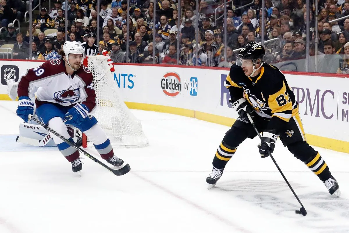 Pittsburgh Penguins center Sidney Crosby (87) and Colorado Avalanche defenseman Samuel Girard (49) during the first period at PPG Paints Arena.