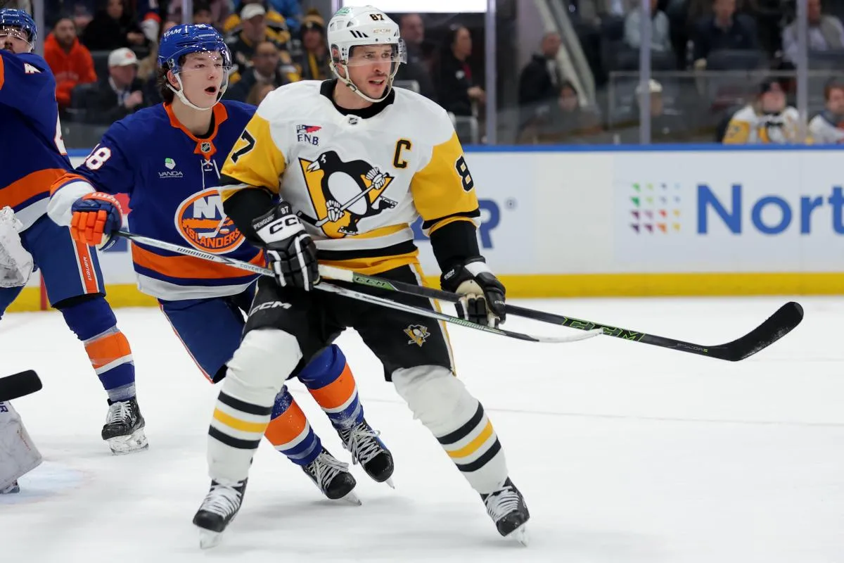Pittsburgh Penguins center Sidney Crosby (87) skates against New York Islanders defenseman Matthew Schaefer (48) during the first period at UBS Arena.