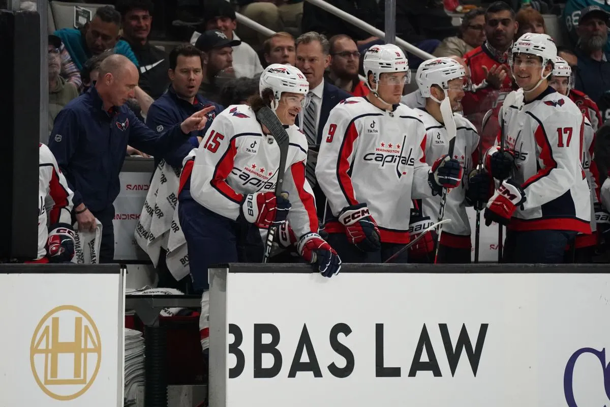 Washington Capitals left winger Sonny Milano (15) returns to the bench after scoring a goal as right winger Ryan Leonard (9) and center Dylan Strome (17) look on against the San Jose Sharks in the first period at SAP Center at San Jose.
