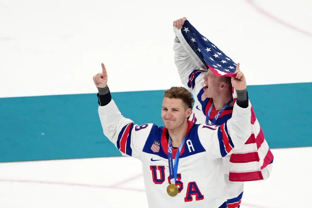 Brady Tkachuk and Matthew Tkachuk of the United States celebrate after winning the men's ice hockey gold medal game during the Milano Cortina 2026 Olympic Winter Games at Milano Santagiulia Ice Hockey Arena.