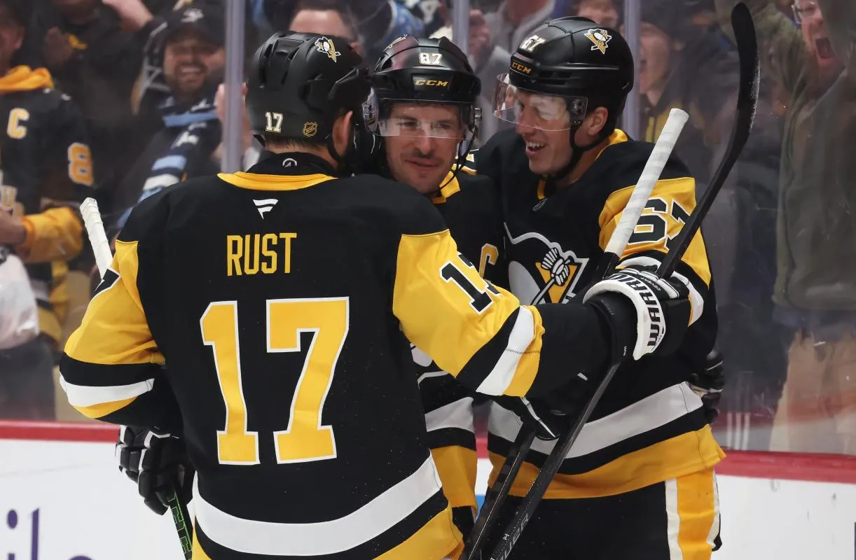 Pittsburgh Penguins right wing Bryan Rust (17) and Pittsburgh Penguins right wing Rickard Rakell (67) congratulate center Sidney Crosby (87) on his assist against the Montr&eacute;al Canadiens to set the Penguins franchise record for career points with 1724 points during the first period at PPG Paints Arena.