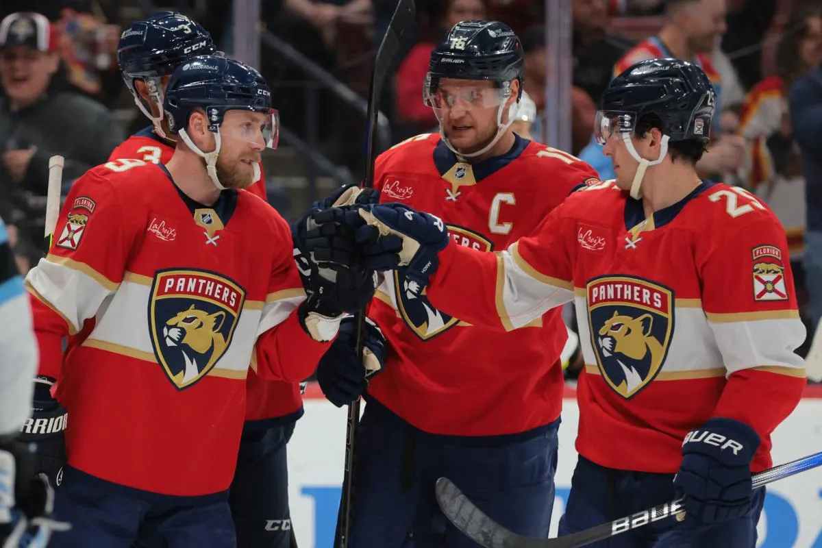 Florida Panthers center Sam Bennett (9) celebrates with right wing Mackie Samoskevich (25) and center Aleksander Barkov (16) after scoring against the Utah Hockey Club during the second period at Amerant Bank Arena