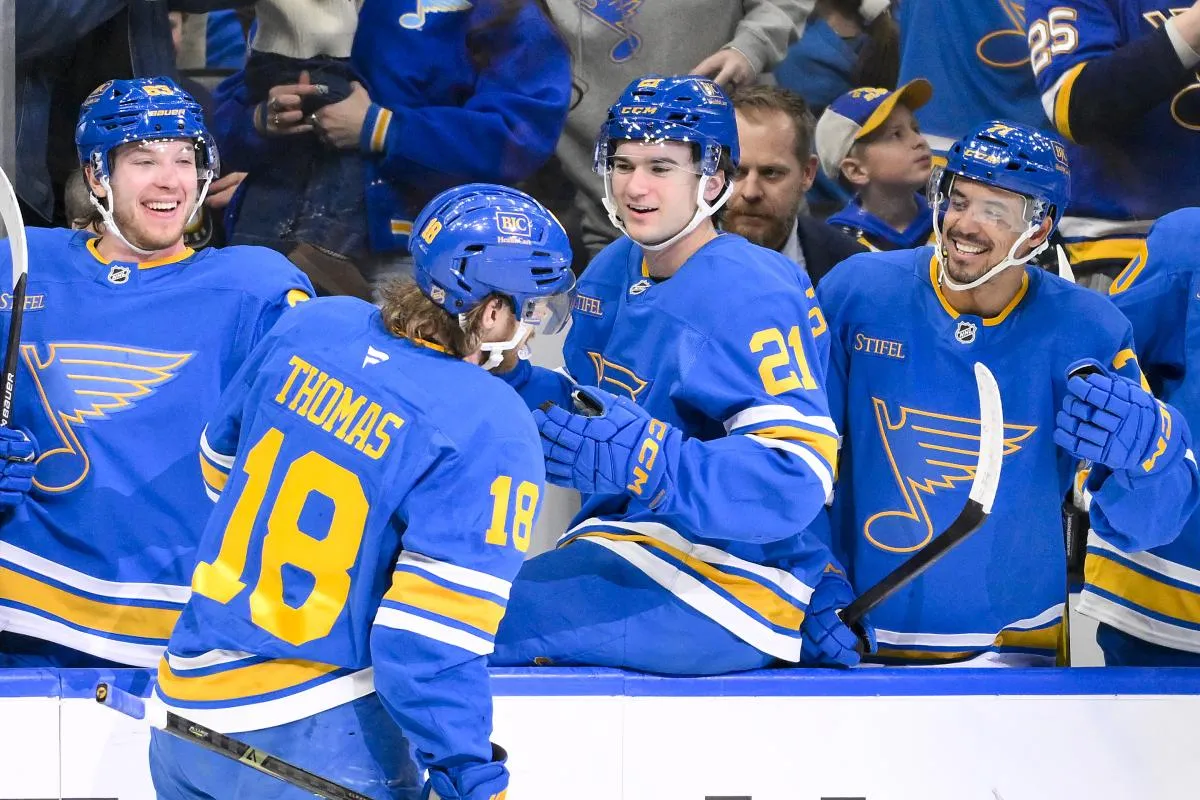 St. Louis Blues center Robert Thomas (18) is congratulated by left wing Jake Neighbours (63) right wing Jimmy Snuggerud (21) and right wing Mathieu Joseph (71) after scoring a shorthanded goal against the Montreal Canadiens during the second period at Enterprise Center.