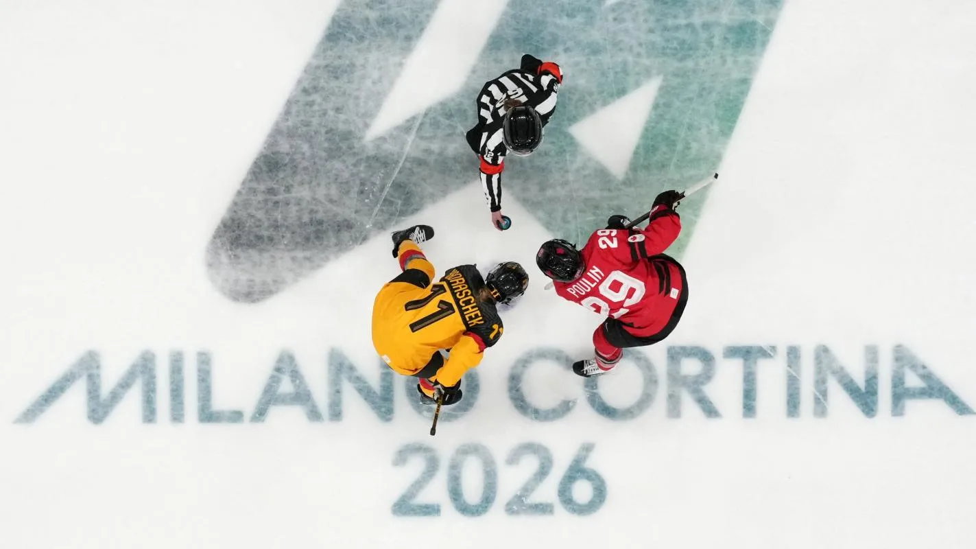 General view of Marie-Philip Poulin of Canada and Nicola Hadraschek of Germany in action during a face-off in a women's ice hockey quarterfinal during the Milano Cortina 2026 Olympic Winter Games at Milano Rho Ice Hockey Arena.