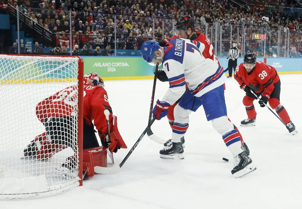 Jordan Binnington (50) of Canada makes a save against Brady Tkachuk (7) of the United States in the men's ice hockey gold medal game during the Milano Cortina 2026 Olympic Winter Games at Milano Santagiulia Ice Hockey Arena.