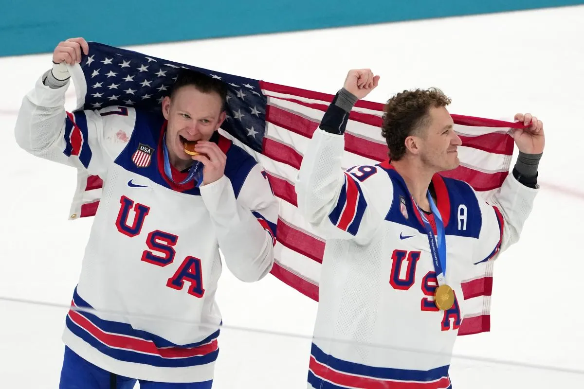 Brady Tkachuk and Matthew Tkachuk of the United States celebrate after winning the men's ice hockey gold medal game during the Milano Cortina 2026 Olympic Winter Games at Milano Santagiulia Ice Hockey Arena.