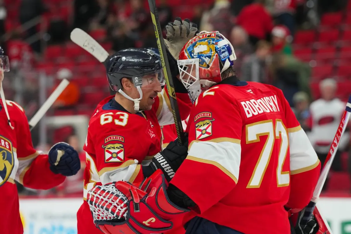 Florida Panthers left wing Brad Marchand (63) and goaltender Sergei Bobrovsky (72) celebrate their victory against the Carolina Hurricanes at Lenovo Center.