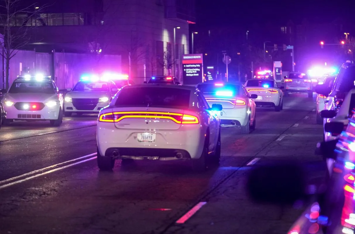 A procession of police cars follow an ambulance after Brian Elliott, 33, a Beech Grove police officer, was killed Monday, Feb. 16, 2026, outside Sidney  Lois Eskenazi Hospital in Indianapolis.