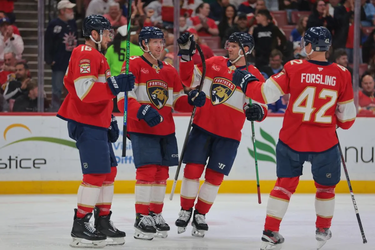 Florida Panthers center Carter Verhaeghe (23) celebrates with center Aleksander Barkov (16) and defenseman Dmitry Kulikov (7) after scoring against the New York Rangers during the second period at Amerant Bank Arena.