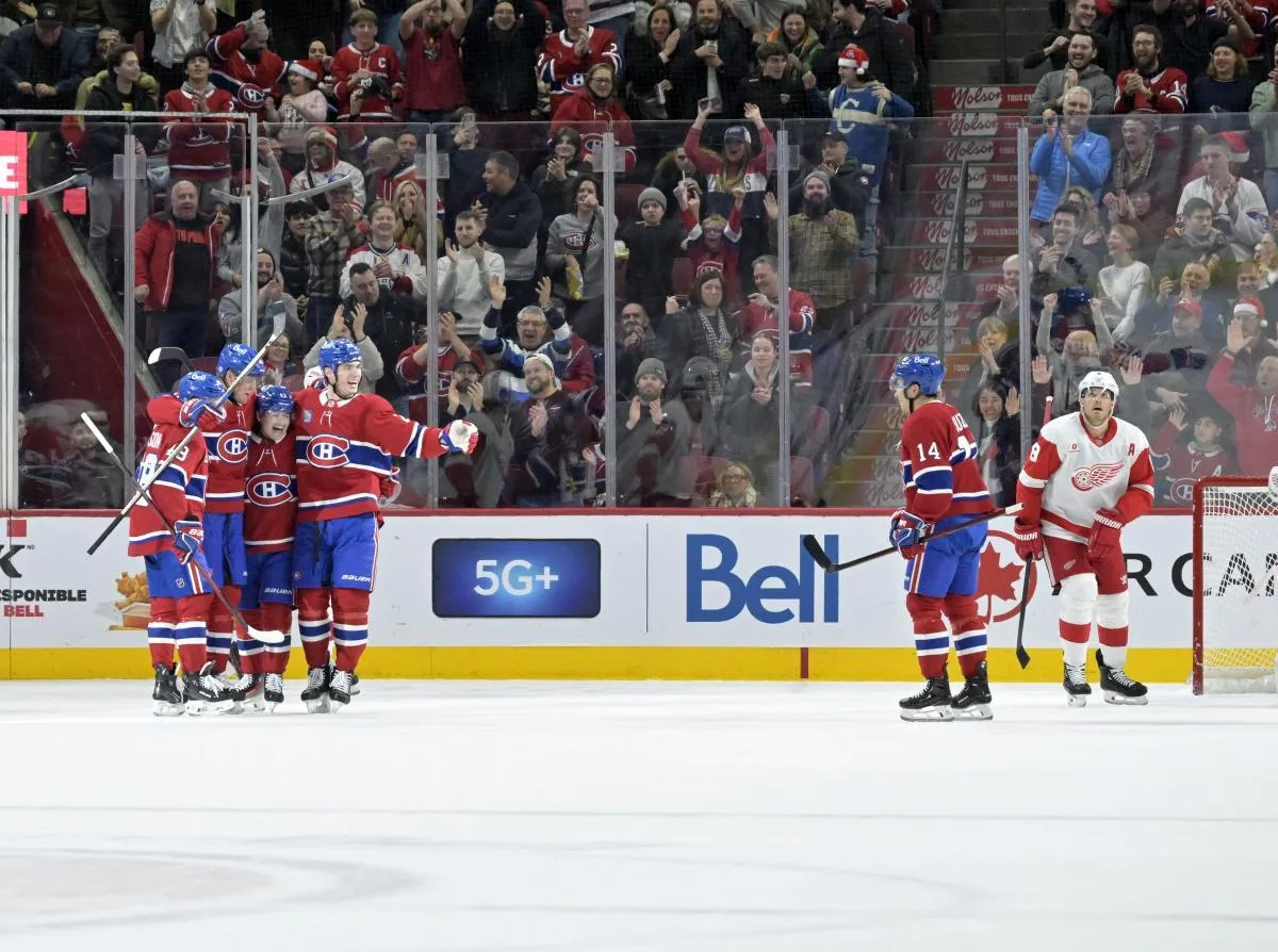Montreal Canadiens forward Patrik Laine (92) celebrates with teammates including forward Cole Caufield (13) and forward Juraj Slafkovsky (20) and defenseman Lane Hutson (48) and forward Nick Suzuki (14) after scoring a goal against the Detroit Red Wings during the first period at the Bell Centre.