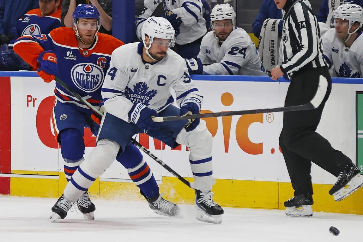 Toronto Maple Leafs forward Auston Matthews (34) and Edmonton Oilers forward Connor McDavid (97) chase a loose puck during the first period at Rogers Place