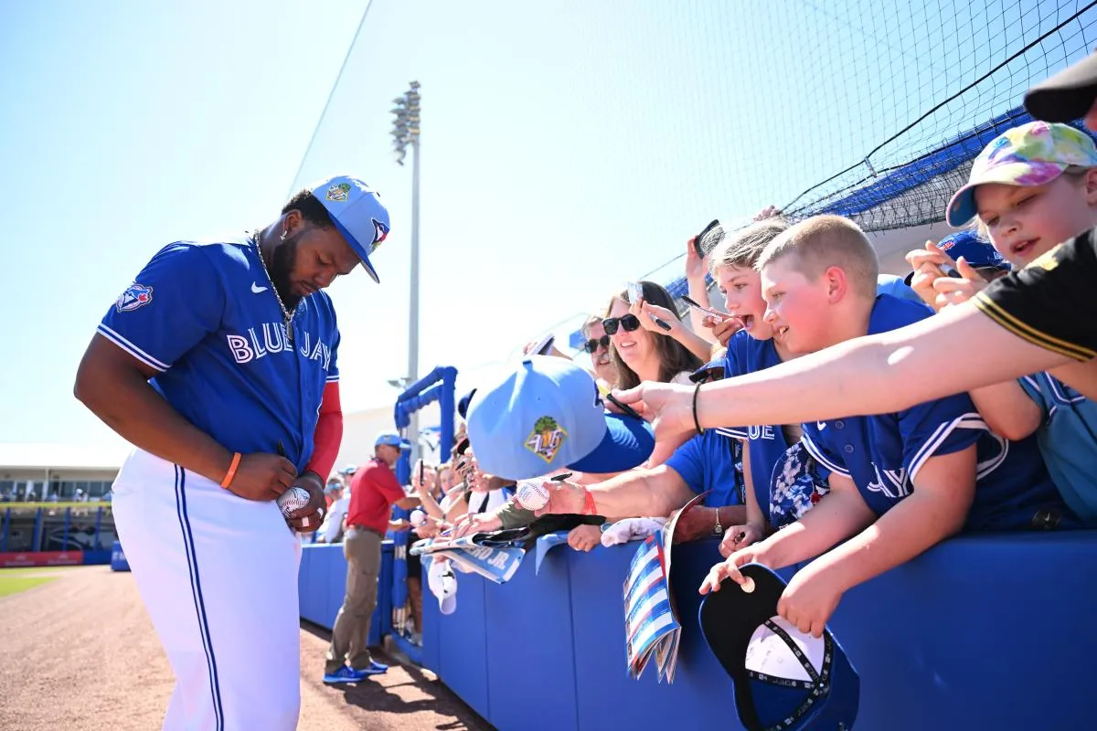 Toronto Blue Jays first baseman Vladimir Guerrero Jr. (27) signs autographs before the start of the game against the Philadelphia Phillies during spring training at TD Ballpark.