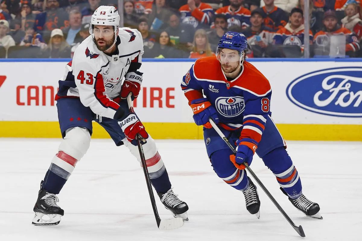 Washington Capitals forward Tom Wilson (43) and Edmonton Oilers forward Andrew Mangiapane (88) looks for a loose puck during the second period at Rogers Place.