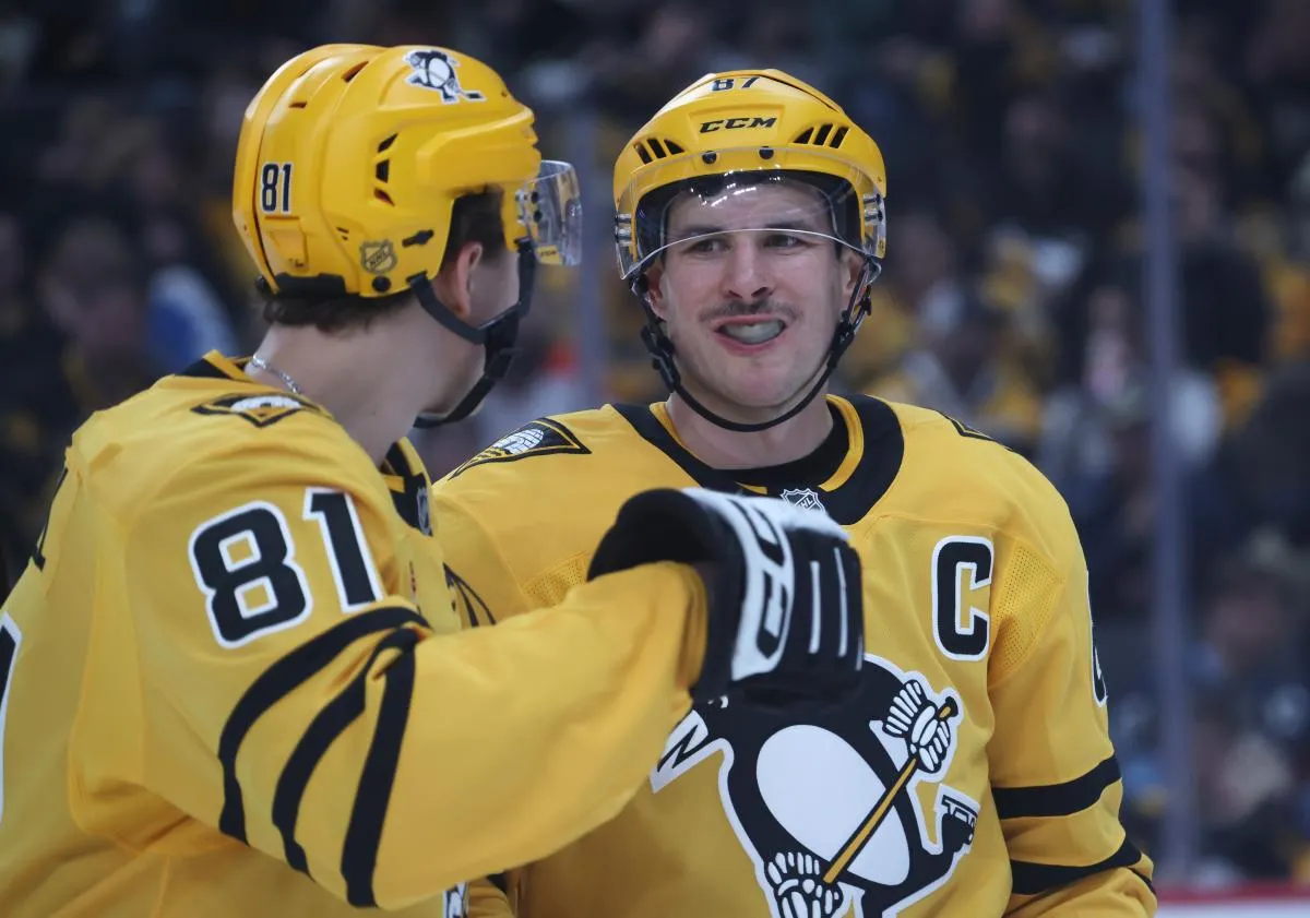 Pittsburgh Penguins center Ben Kindel (81) and Pittsburgh Penguins center Sidney Crosby (87) talk before a face-off against the Washington Capitals during the first period at PPG Paints Arena.