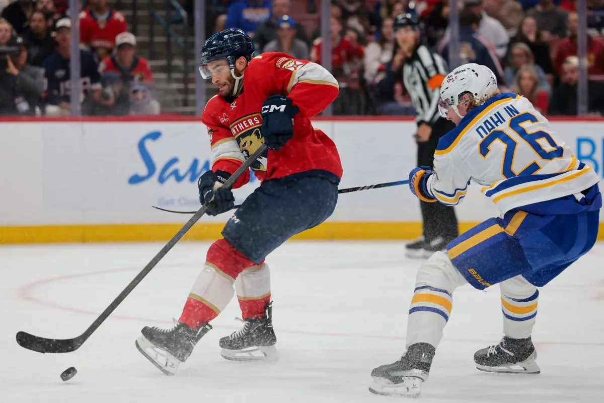 Florida Panthers center Luke Kunin (71) moves the puck against Buffalo Sabres defenseman Rasmus Dahlin (26) during the second period at Amerant Bank Arena.