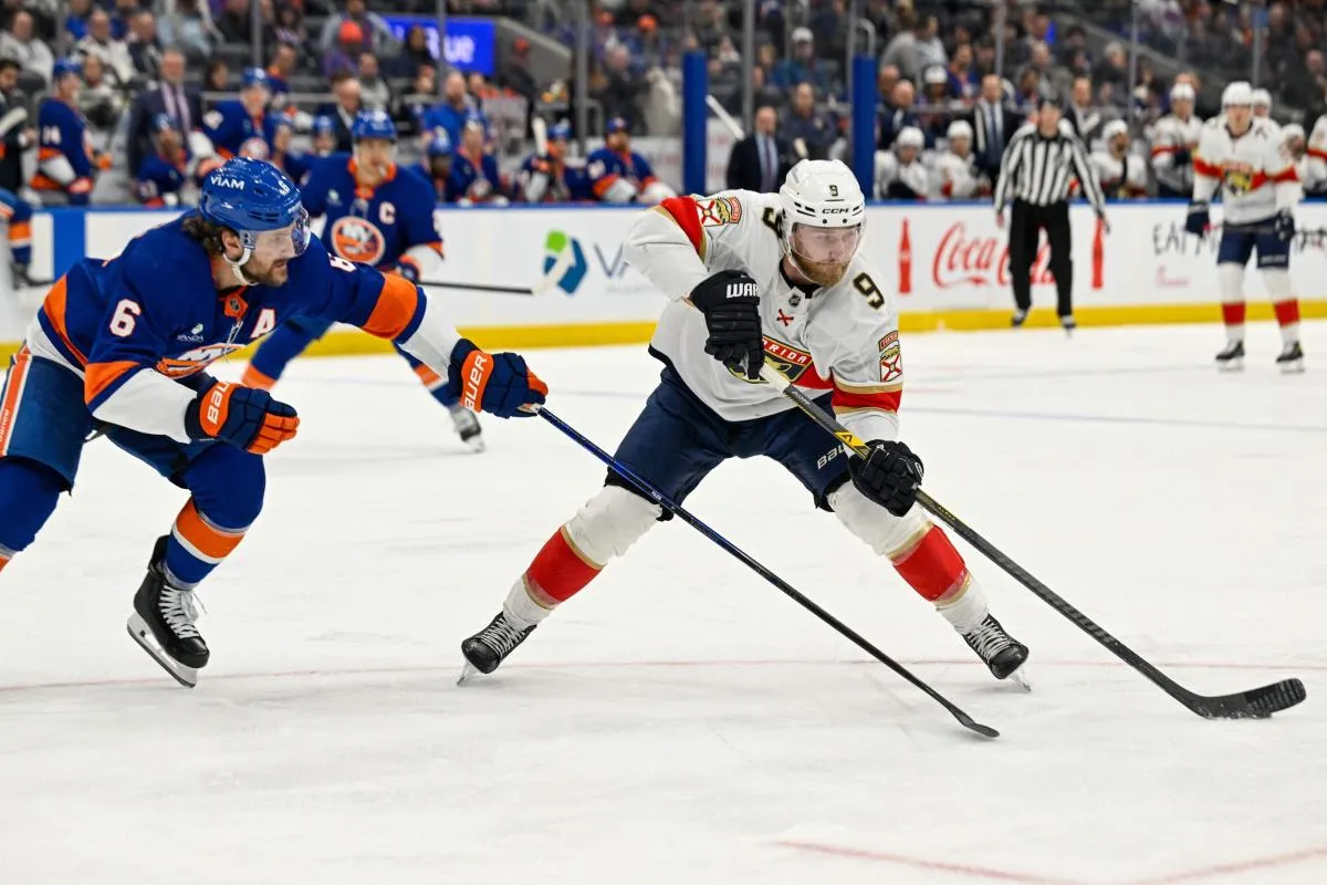 Florida Panthers center Sam Bennett (9) skates with the puck defended by by New York Islanders defenseman Ryan Pulock (6) during the third period at UBS Arena.