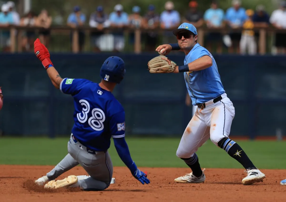 Tampa Bay Rays infielder Ben Williamson (15) forces out Toronto Blue Jays right fielder Nathan Lukes (38) and throws the ball to first base for an out during the third inning at Charlotte Sports Park.